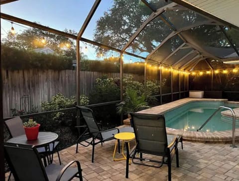 The backyard with the lights at night is magical