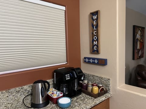 Coffee/tea bar with more supplies in drawer and cupboard