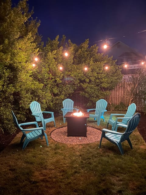 Gas fire pit with ample seating and string lights for the perfect evening hang
