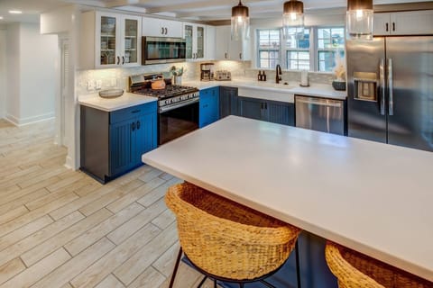 The beautiful newly renovated kitchen offers an abundance of counter space, making meal preparation and service a breeze.