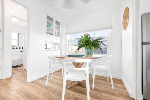 Dining table seats 4 people is in its own dining area in the home.