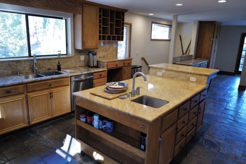 Gourmet kitchen with double ovens, gas rangetop, spacious countertops, & island