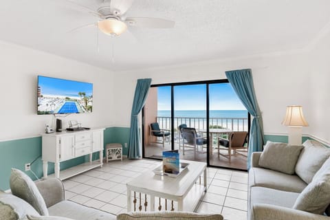 Relax in your bright oceanfront living room with panoramic sea views and coastal breezes flowing through your private balcony.
