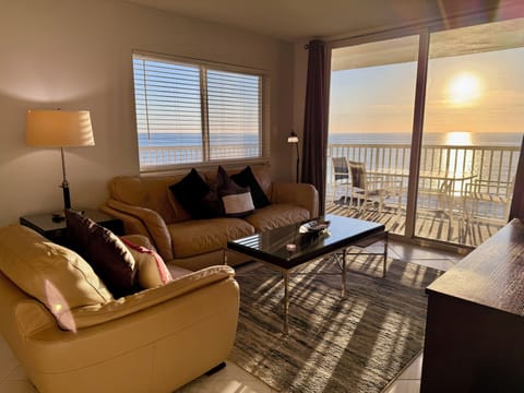 Unwind in your oceanfront living room where golden sunlight streams through windows, creating perfect ambiance for morning coffee or sunset cocktails.