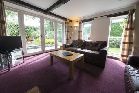 Secret Cottage Coniston sitting room with patio doors to garden