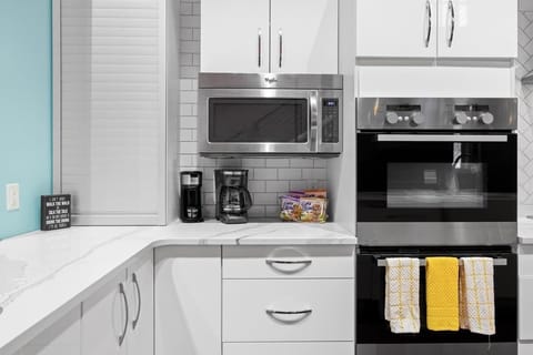 Complete chef's kitchen with coffee bar, double oven, and microwave.