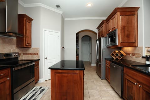 Spacious French Door Refrigerator, microwave, and dishwasher with kitchen Island