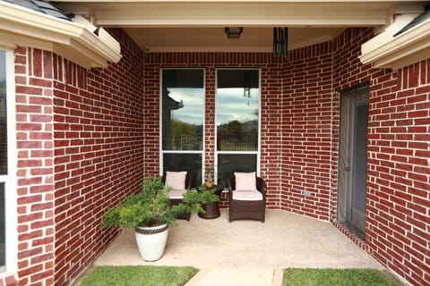 Covered patio with view to the community lake in the backyard