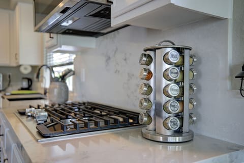 Kitchen is fully stocked with spices, oil, vinegar, salt and pepper.