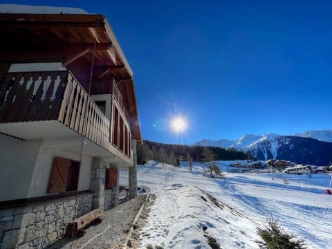 Exterior of chalet with the piste next to the chalet.