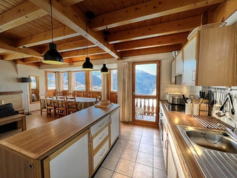 Fully equipped kitchen with balcony access and stunning views