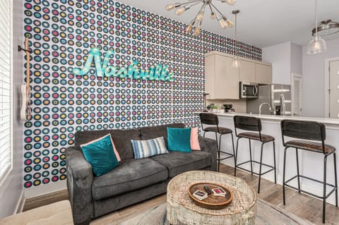 Cozy living room area with a pull-out sofa plus Smart TV with apps. Seating for 5 at the kitchen counter.