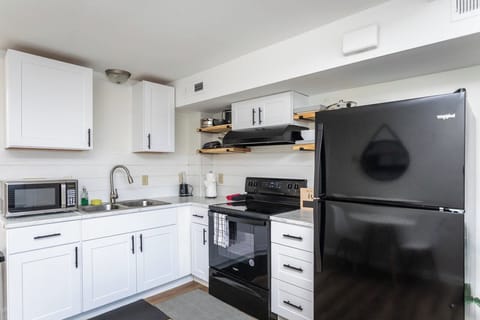 Full-size kitchen with refrigerator, stove/oven, and microwave