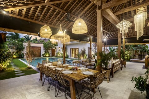 Illuminated dining area with a pool view 