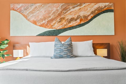 Main bedroom with king-sized bed and oversized, commissioned artwork 
