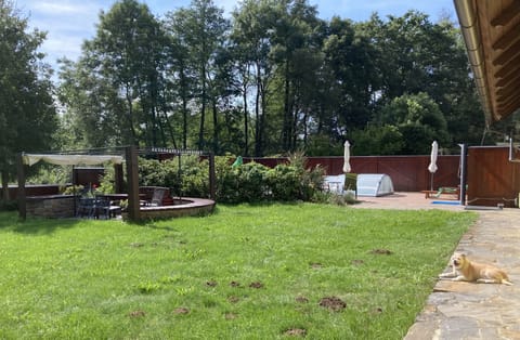 Fenced in yard with swimming, pool, and seating area & play area
