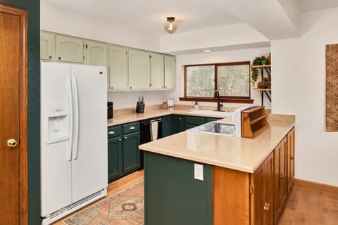 Kitchen with fridge/freezer, dishwasher, stove, and well stocked cabinets