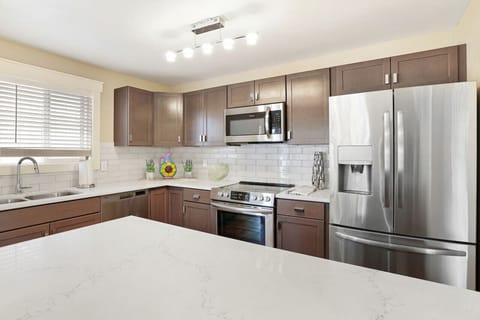 Fully stocked kitchen open into the dining room with a view of a lake.Seattle /Tacoma Area.