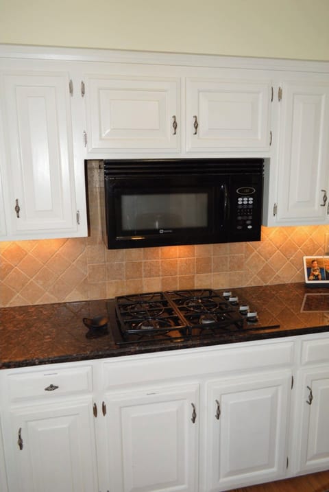 The Kitchen: Gas range and microwave plus pots & pans, dishes and more.