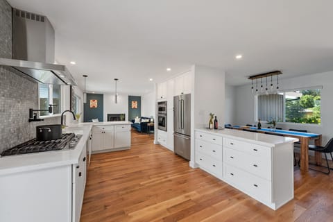 Chef's kitchen with view of living room and dinning area