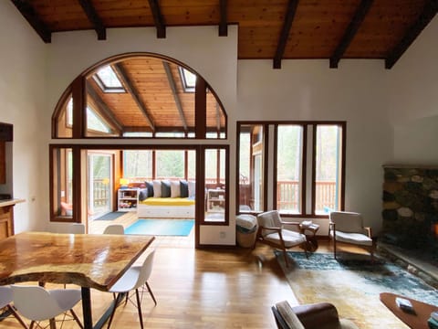 Living-Dining areas with lofted ceiling and Sunroom beyond