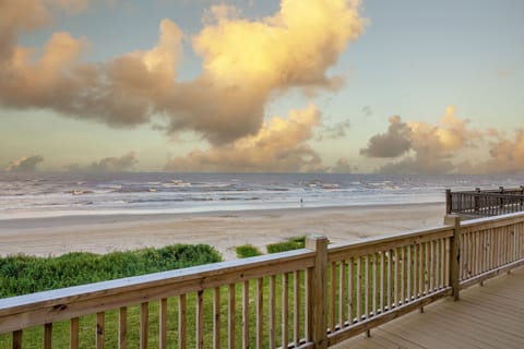 Catch all the colors of the sunset over the open water and sand right from our deck!.