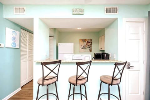 There is a breakfast bar with three barstools to enjoy meals, or even setup your workstation if you're on a "work from home" trip.