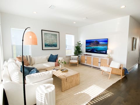Cozy main floor living room with 75" inch smart TV and space for a crowd
