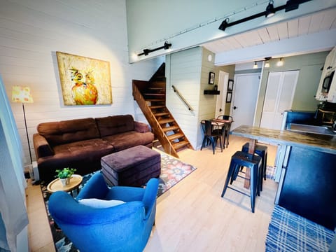 Wide angle view shows the layout of the living room and kitchen area.