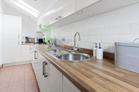 A modern, bright and airy galley style kitchen complete with cooking facilities, dishwasher, kettle and coffee machine. A washing machine and drier can also be found in the utility room.