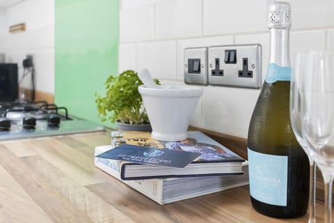 A modern, bright and airy galley style kitchen complete with cooking facilities, dishwasher, kettle and coffee machine. A washing machine and drier can also be found in the utility room.