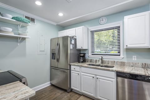 Put on your chef hat in this modem kitchen  stocked with pots, pans & utensils.