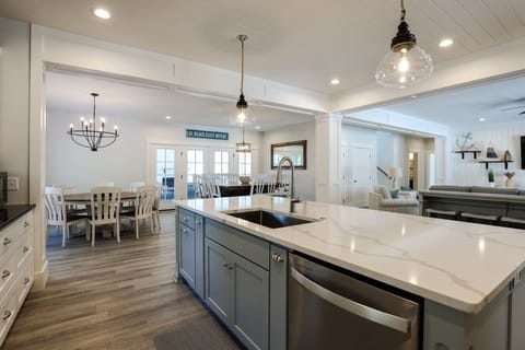 Kitchen view towards dining area and screened porch