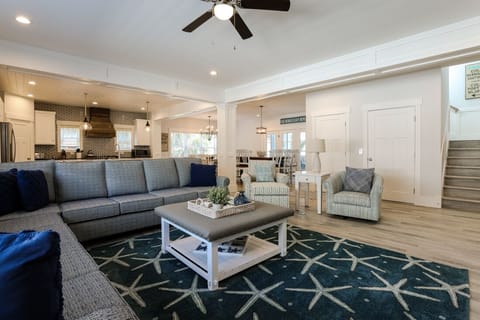 Family room view towards kitchen and dining room; Elevator next to stairway
