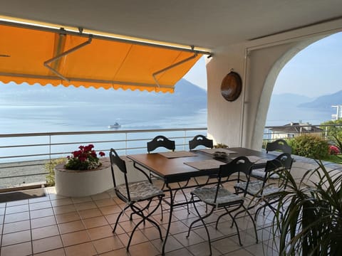 Sky, Table, Property, Furniture, Plant, Flowerpot, Shade, Outdoor Furniture, Architecture, Chair