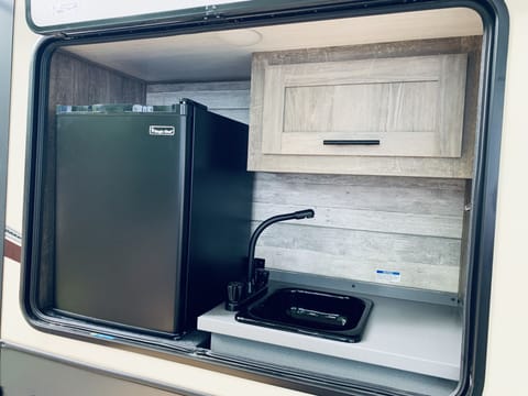 Outdoor sink with mini fridge! Great place to keep those beverages! 