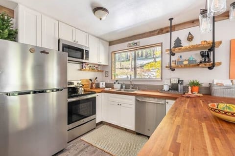 Modern kitchen with microwave, dishwasher, stove, fridge & garbage disposal