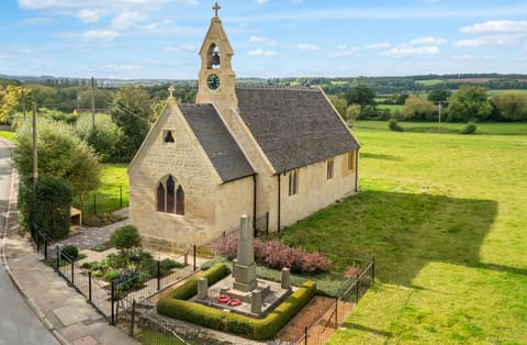Restored exterior has views over farmland and Cotswold hills.