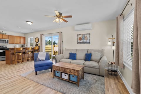 Living area, full kitchen with bar stools and, side access to the patio.