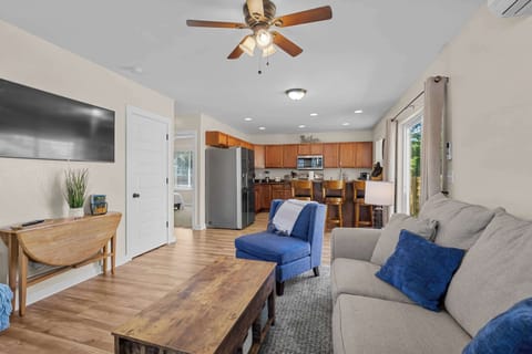 Living area, full kitchen with bar stools and, side access to the patio.
