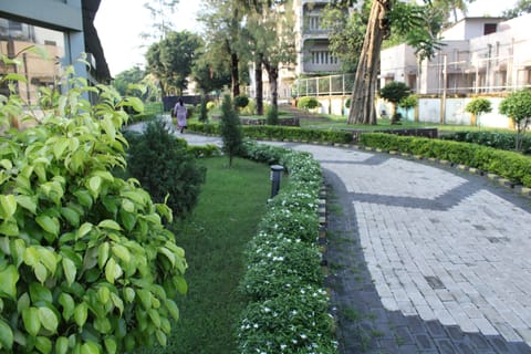 A green verge adjacent to 'Happy Home'.