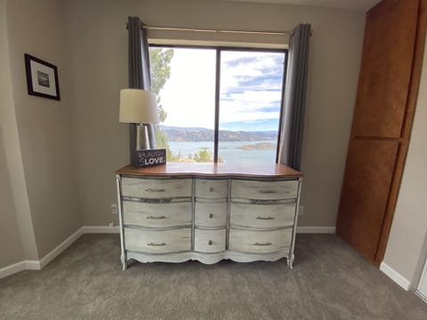 view of lake out window with queen bed 