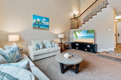 Cozy living room with plush sofas and large flat screen TV.
