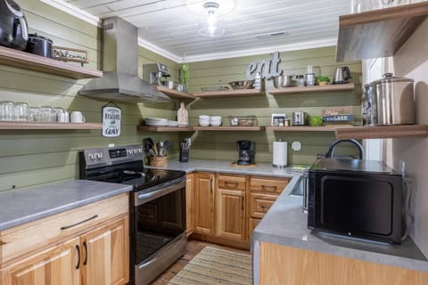 Discover culinary delight in our modern kitchen equipped with sleek appliances, including an oven, coffee maker, kitchenette, and microwave. Elevate your stay with a contemporary cooking experience