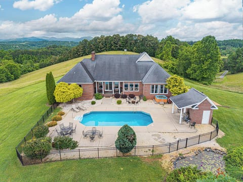 Get ready to be “wowed” by this 4,500+ sq. ft. spectacular modern, brick, Colonial-style retreat estate with soaring vistas.