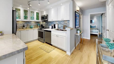 The kitchen is situated in the center of the condo for easy access from anywhere