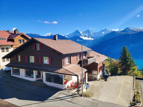 Sky, Property, Window, Building, Mountain, World, Cloud, Plant, Slope, House