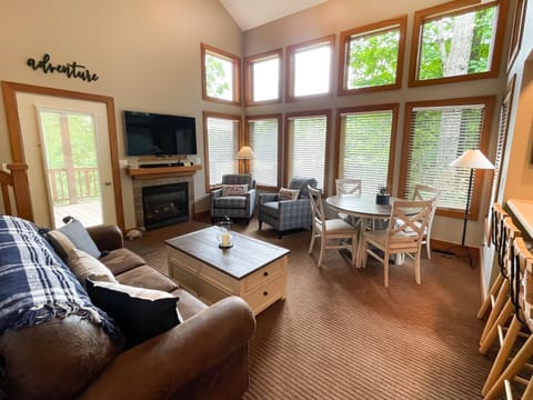 Plenty of seating for your whole group - This upstairs den with a fireplace leads right out to the Boyneland run off the deck door.