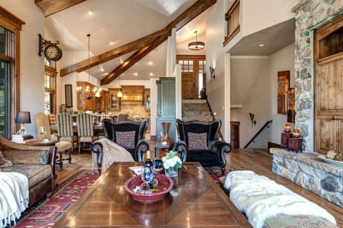 Spacious rustic living area with elegant furniture and warm wood accents.