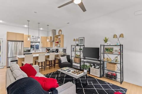 Spacious open‑concept living area with plush seating and a breakfast bar, perfect for relaxing or planning your adventures.